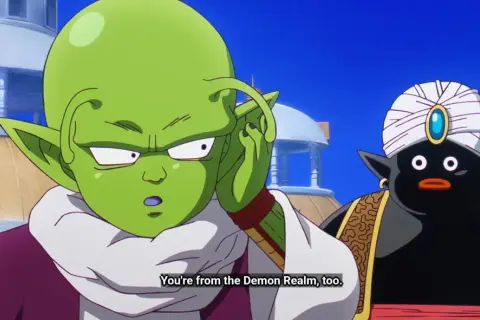 Zielony kosmita z antenkami i czarny Mr. Popo w turbanie rozmawiają.