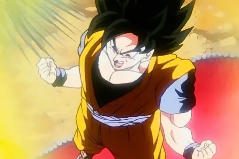 Son Goku w trakcie jednej ze swoich potężnych przemian, otoczony oślepiającym blaskiem energii.