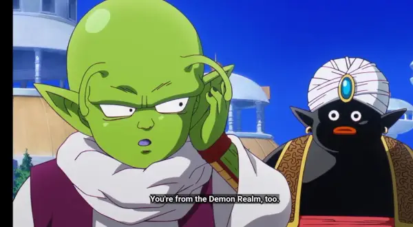 Zielony kosmita z antenkami i czarny Mr. Popo w turbanie rozmawiają.