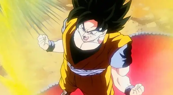 Son Goku w trakcie jednej ze swoich potężnych przemian, otoczony oślepiającym blaskiem energii.