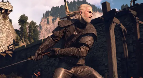 Geralt w zbroi zapomnianego wilka, z mieczem w dłoni, gotowy do walki. W tle góry i ruiny zamku.