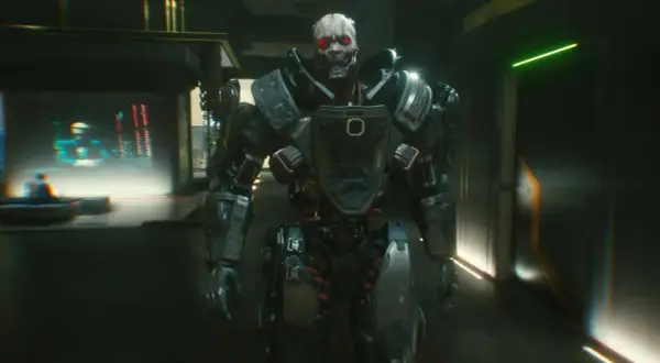 Adam Smasher, potężny cyborg z czerwonymi oczami, wchodzi do mrocznego korytarza.