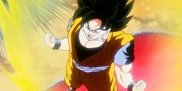 Son Goku w trakcie jednej ze swoich potężnych przemian, otoczony oślepiającym blaskiem energii.