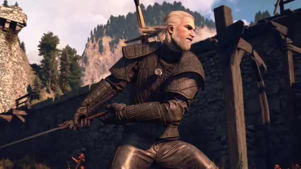 Geralt w zbroi zapomnianego wilka, z mieczem w dłoni, gotowy do walki. W tle góry i ruiny zamku.